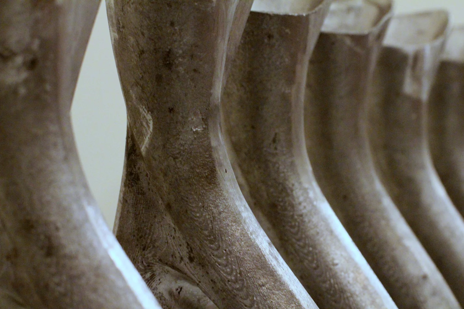 Close-up of a wooden banister with multiple rounded spindles.